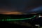 Titan RT suspension rope bridge illuminated in green at night over the Rappbodetal