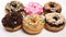 Title assortment of delicious chocolate glazed doughnuts in different flavors and shapes