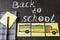 Title Back to school and the picture of school bus drawn on pieces of paper and notebook