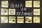 Title Back to school written by chalk and images of school bus and attributes written on the pieces of paper