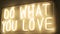 Title do what you love made of yellow neon light on wall. festive decoration
