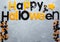 Title Happy Halloween on the gray background. Decoration, flat lay