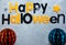 Title Happy Halloween on the gray background. Decoration, flat lay