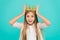 Title miss little princess. Girl wear crown blue background. Cute emotional sincere princess. Kid wear golden crown