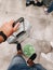 Tivat, Montenegro - 29 july 2020: Close-up of a hand holding the handle of a suitcase rewound with film. Pasted