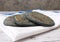 Tlacoyo on a white napkin with blue edges, on a wooden board