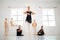 To dance is to be out of yourself. a group of ballet dancers practicing a routine in a dance studio.