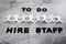 To Do Hire Staff text with paper people chain and question marks on vacant positions to fill, staff shortages and workforce