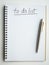 To do list concept.`to do list,` handwritten text font with underline on blank space on a white page of simple spiral notebook.