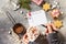 To-do list and Female hands holding a cup of hot cocoa with marshmallows, Christmas sweets on a stone countertop.