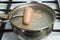 To get out of a pot of boiling water boiled sausages. The hot sausage is on the fork. Cooking at home on the gas stove.