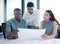 Always to go the extra mile. Shot of a group of young contractors reviewing a set of building plans.