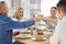 To many, many more. a family toasting with wine while having lunch together at home.