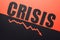 To view of word crisis and recession arrow on black and red background divided by sloping line.