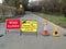 Toads in the road closed sign. Migrating wildlife nature conservation.