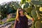 Toarmina - Portrait of a beautiful model woman in dress next to a field of green cactus flowers on Sicily, Italy