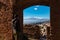 Toarmina - Tourist man with panoramic view on snow capped Mount Etna volcano seen from ancient Greek theatre of Taormina, Italy