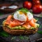 Toast with avocado dip, salmon and poached egg, close up. Sandwich with guacamole, salmon slices and poached egg on dark rye bread