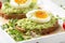 Toast with avocado puree and soft-boiled egg on white tray, liquid yolk, delicious breakfast, light sandwich. Healthy food