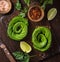 Toast with avocado roses on wooden cutting board