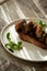 Toast with baked chicken liver on white plate on table