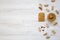 Toast, bowl of peanut butter and peanuts in shells on a white wooden background, top view. Copy space.