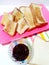 Toast with chocolate sprinkles and butter on a white background and colored stripes