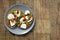 Toast sandwich mozzarella cheese, cherry tomatoes and pesto bruschetta, toast on wooden background. Healthy breakfast, snack. Copy