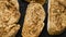 Toasted baguette slices isolated on dark background close up. Close up shot.