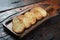 Toasted baguette slices  on rustic wooden kitchen table