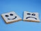 toasted bread with smiley and sad emoticons, for the concept of happiness and sadness