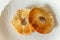 Toasted buttered bagel on a white plate