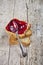 Toasted cereal bread slices stack with homemade cherry jam and spoon closeup on rustic wooden table background