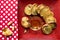 Toasted french bread slices arranged on red plate on patterned table