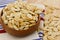 Toasted pumpkin seeds overflowing a wooden bowl