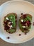 Toasted sourdough bread topped with avocado, feta and pomegranate
