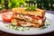 Toasted tomato sandwich on white plate in modern restaurant, breakfast menu concept with copy space