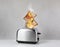 Toaster flaming up while cooking slices of bread on white wooden table. Unsafe appliance