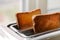 Toaster with ready bread slices in the kitchen. traditional breakfast at home