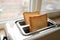 Toaster with ready bread slices in the kitchen. traditional breakfast at home on window. selective focus