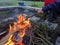 Toasting a marshmallow on the end of a stick over a fire