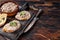 Toasts with Duck pate Rillettes de Canard on wooden board. Dark wooden background. Top View. Copy space