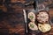 Toasts with Duck pate Rillettes de Canard on wooden board. Dark wooden background. Top View. Copy space