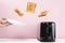 Toasts flew out of modern toaster. Levitation food and dish. Delicious morning breakfast concept on pink background