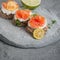 Toasts with lightly salted salmon and cottage cheese cream on a concrete plate.