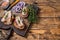 Toasts with sardine, cream cheese and onion. Wooden background. Top view. Copy space