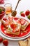 Toasts with strawberries and cream cheese, topped with honey, close-up view.