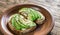 Toasts with tahini sauce and sliced avocado