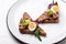 Toasts with tuna delicious healthy food, sandwiches with canned tuna and cucumber, quail eggs and onion on a white plate on a