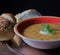 A toasty warm bowl of pumpkin soup and crusty seeded bread